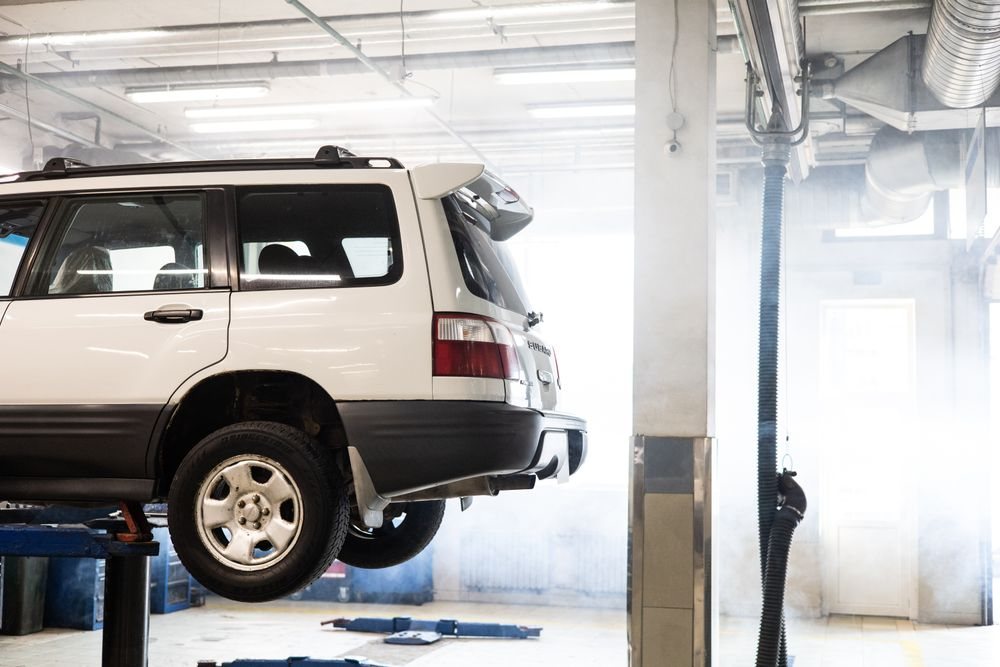 Car on a lift in a bright workshop