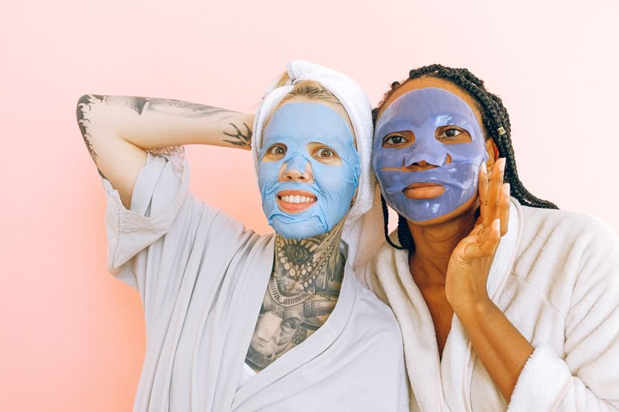 Two friends wearing sheet masks