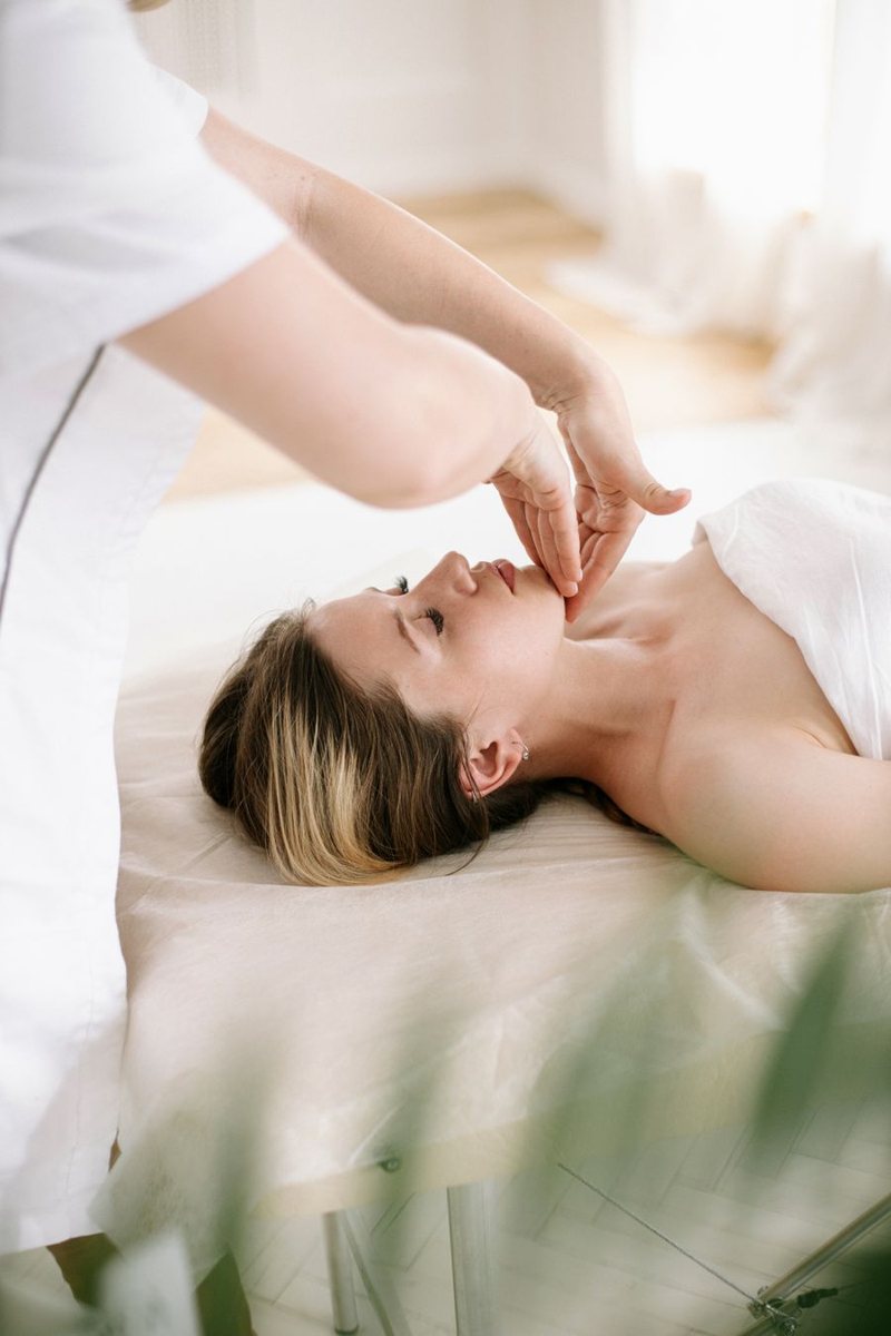 Client relaxing during a facial massage