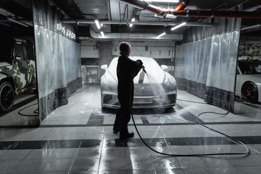Car being cleaned in a wash bay