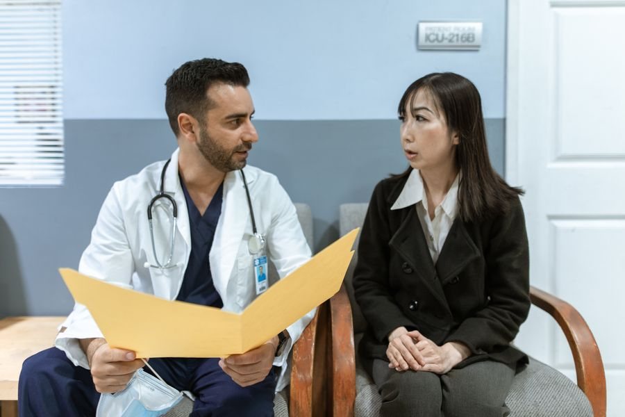 Doctor talking with a patient in a bright consulting room