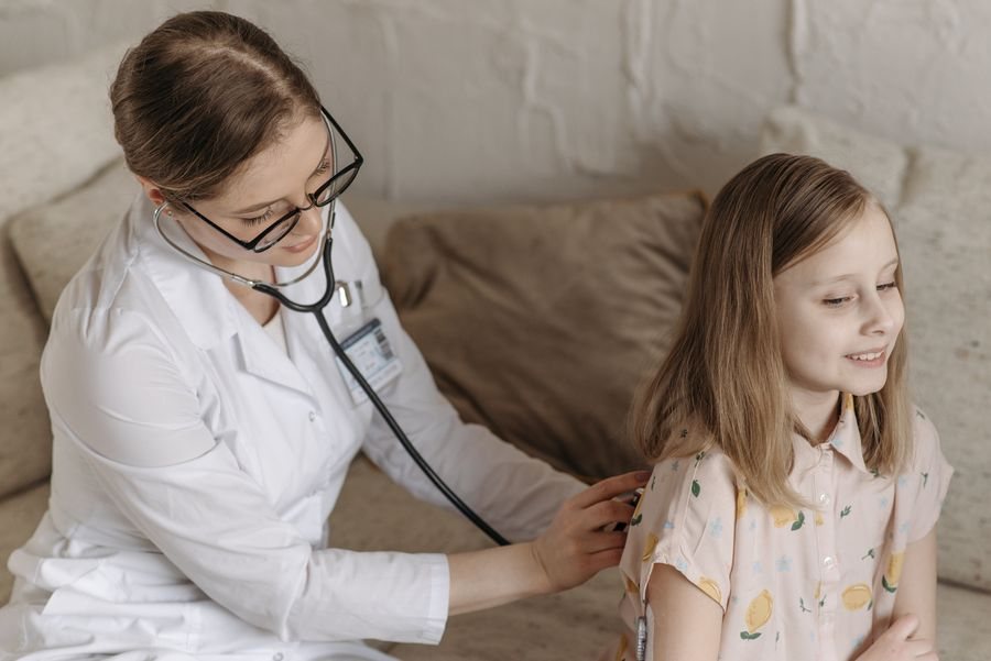Paediatrician listening to a child with a stethoscope
