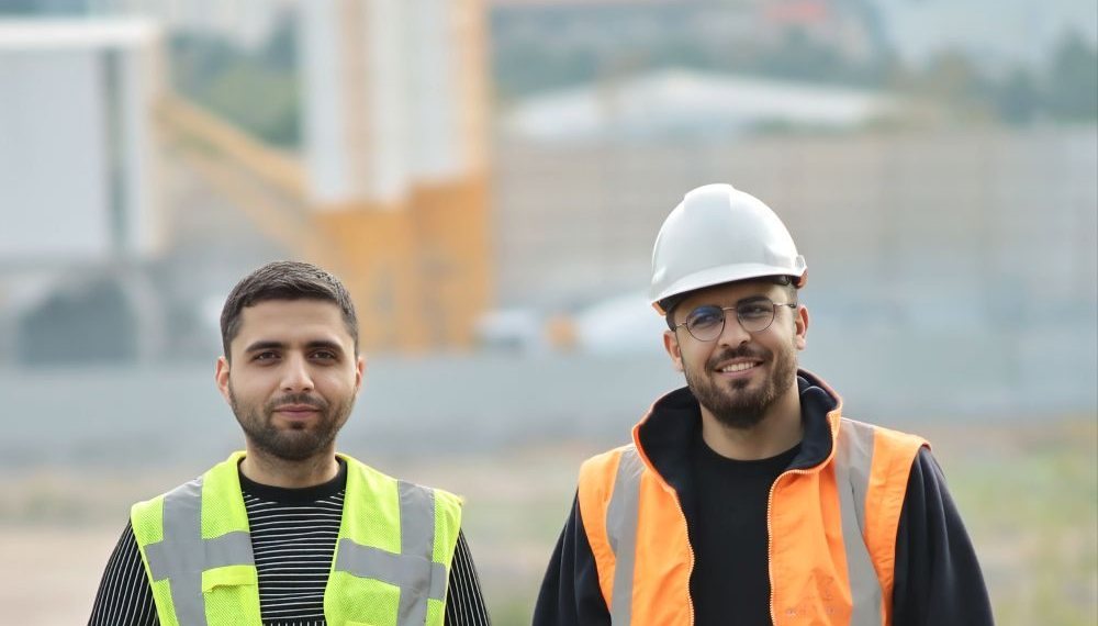 Crew members in high-visibility vests on a job site