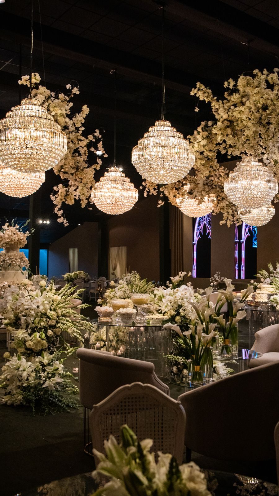 Wedding reception with crystal chandeliers and white flowers