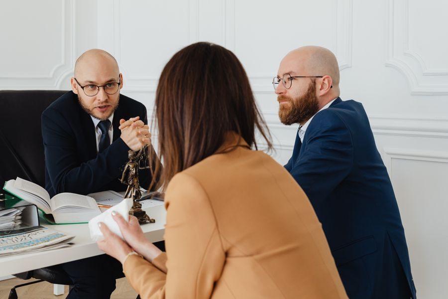 Lawyers meeting a client at a conference table
