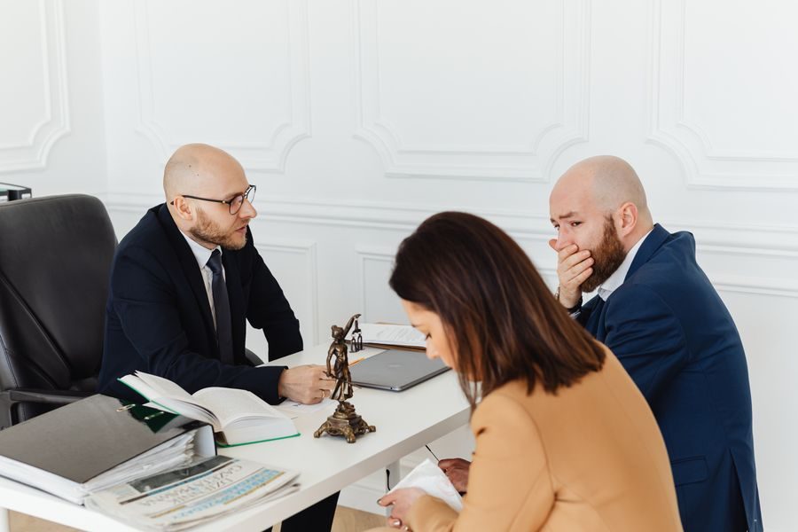 Two lawyers reviewing a case with a client