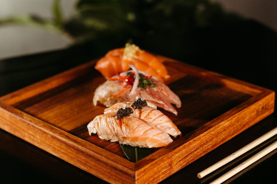 Salmon nigiri on a wooden tray