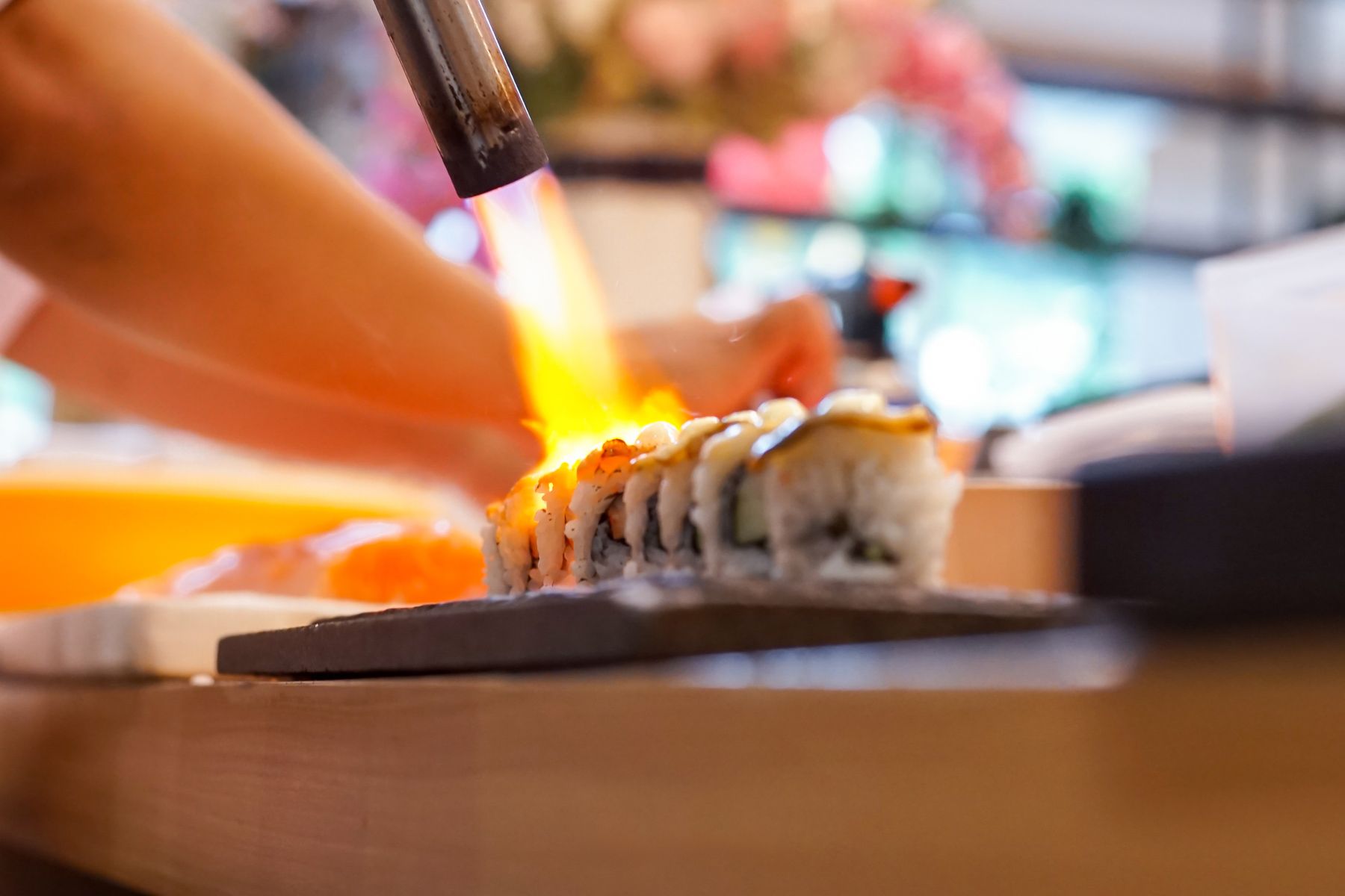 Chef torching nigiri at the Sushi Toro counter