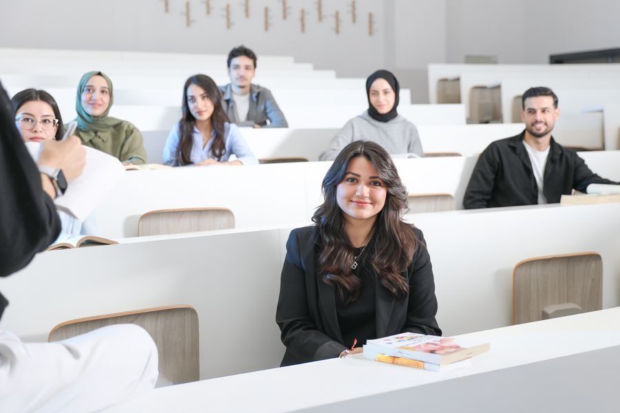 Adult students smiling in a bright classroom