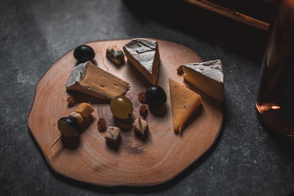 Cheese, figs and nuts on a wooden board