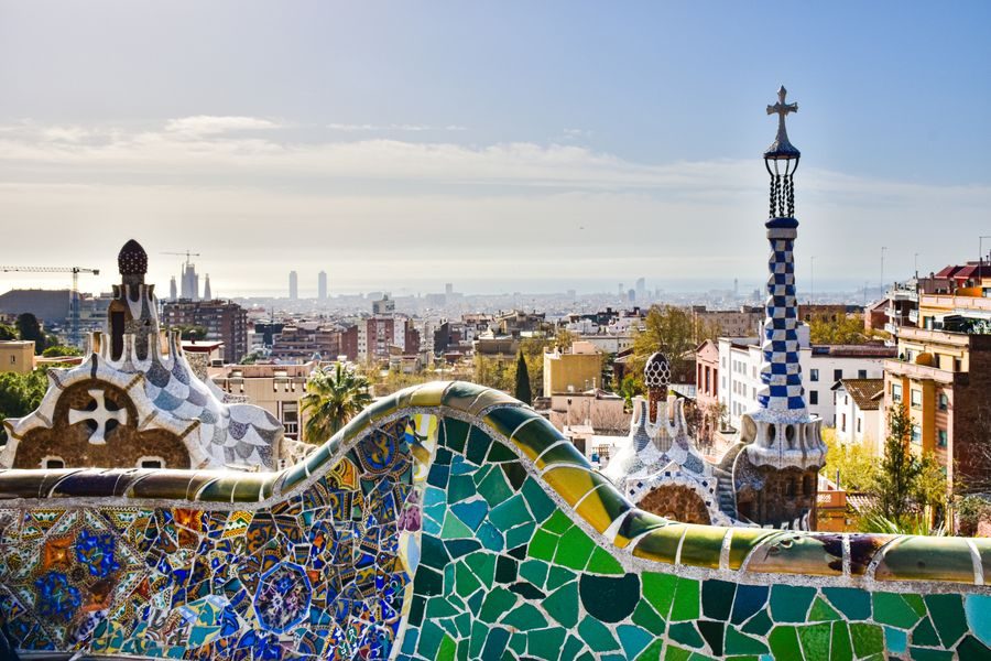 Park Güell mosaic bench and tower over Barcelona